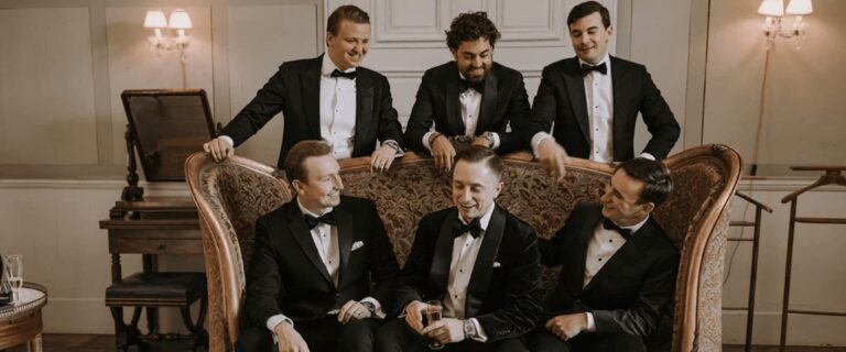 Groom and groomsmen in black tie on a velvet sofa, Daria Events and Weddings