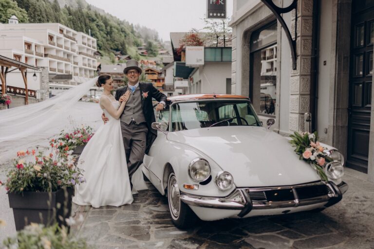 Couple with a vintage Citroën on a Swiss mountain village street, Daria Events and Weddings