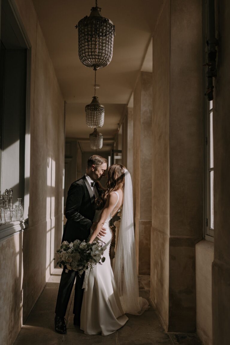 Couple embracing in a vaulted arcade, Château de Mairy, Champagne, France, Daria Events and Weddings