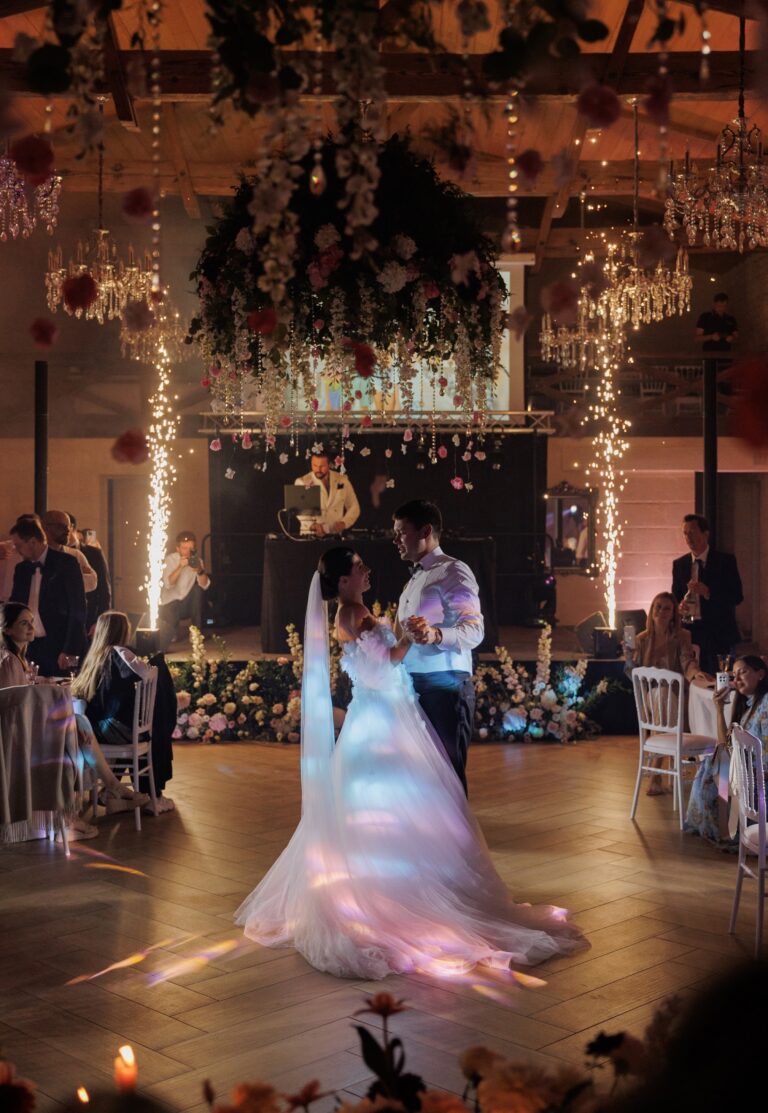 First dance beneath a suspended floral installation with sparklers, Daria Events and Weddings