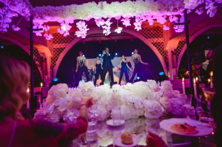 Dancers performing above a bank of white flowers at the top table, Dario Varsalona