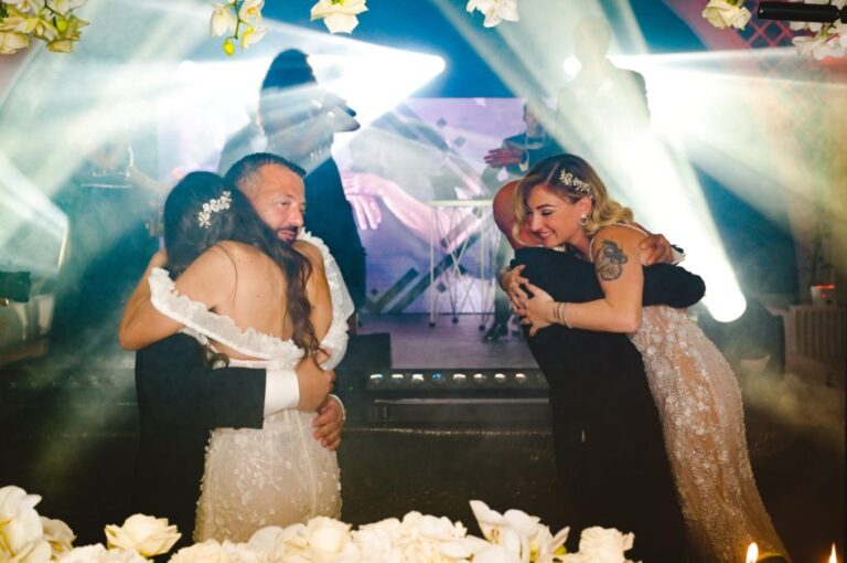 Guests embracing on the dance floor under stage lights, Dario Varsalona
