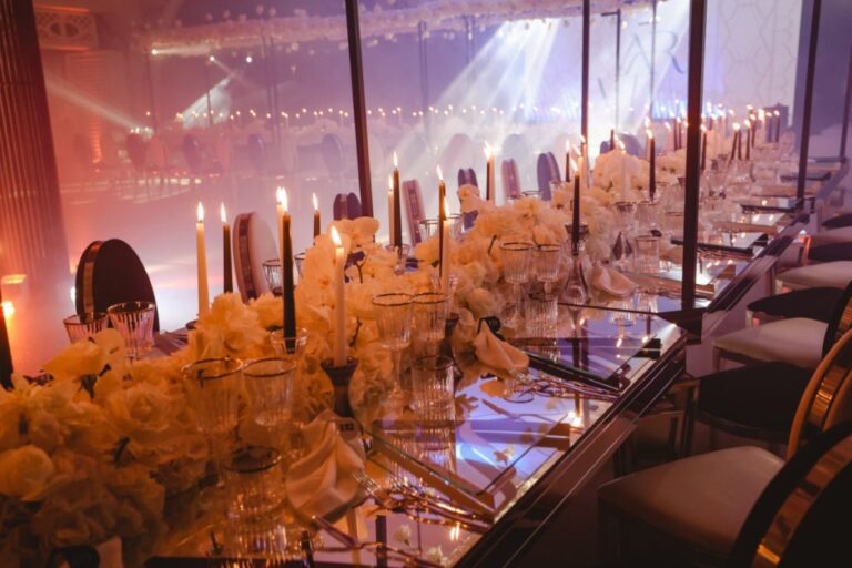 Long mirrored table set with tall tapers and banks of white flowers, Dario Varsalona