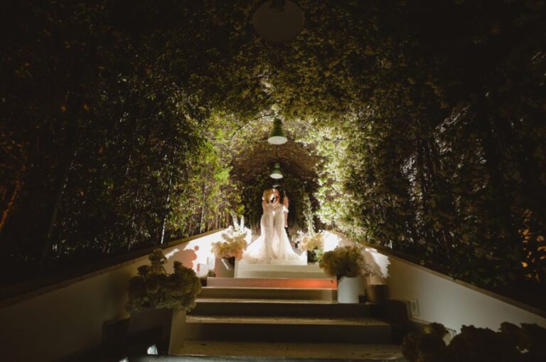 Lit tunnel of foliage leading to the couple at the far end, Dario Varsalona