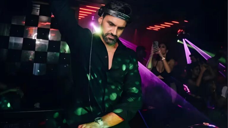 DJ playing under purple lights
