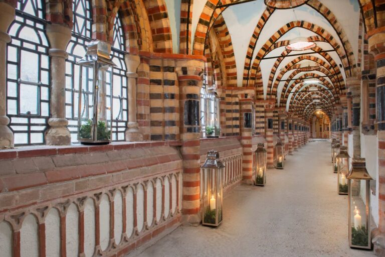 The striped brick cloisters with lanterns along the walkway, De Vere Horsley Estate