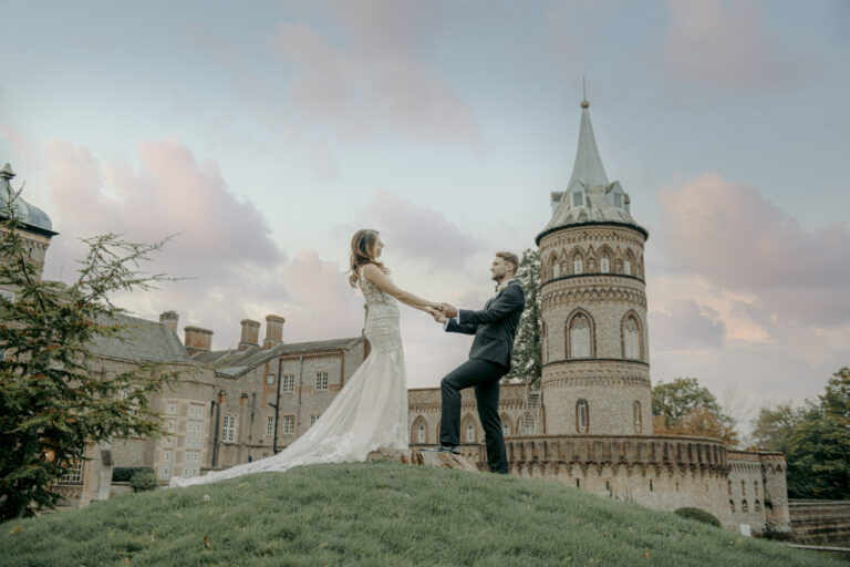 A couple on the lawn below the Italian tower, De Vere Horsley Estate