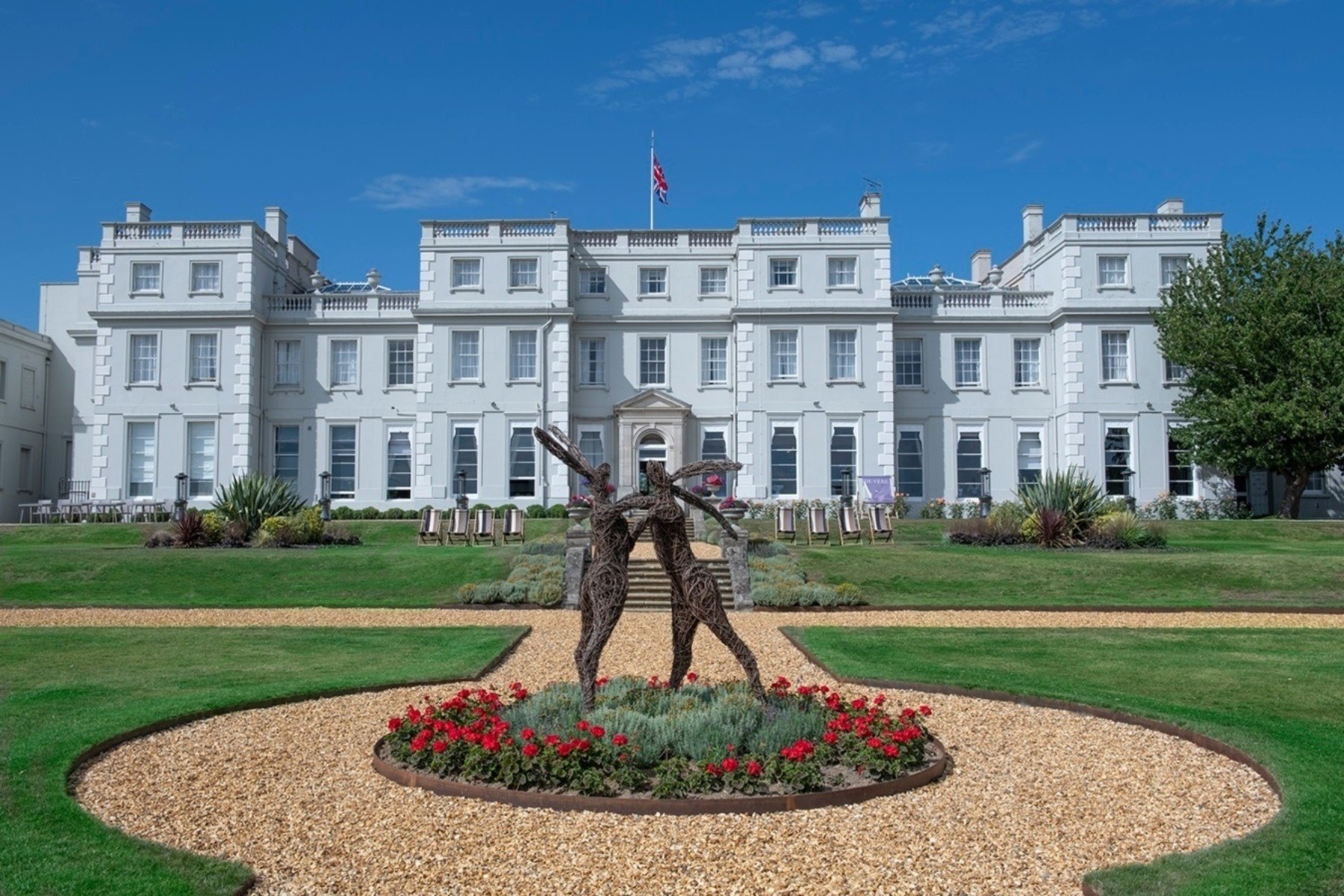 The white mansion house and its garden statue, De Vere Wokefield Estate