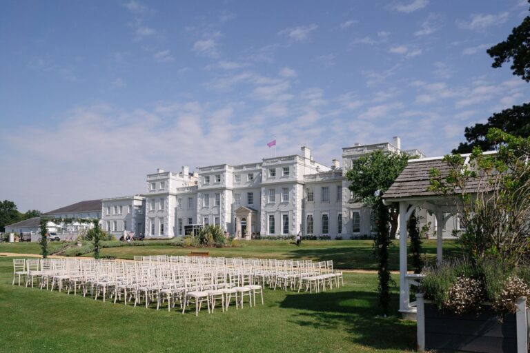 Chairs set on the lawn for a ceremony in front of the mansion, De Vere Wokefield Estate