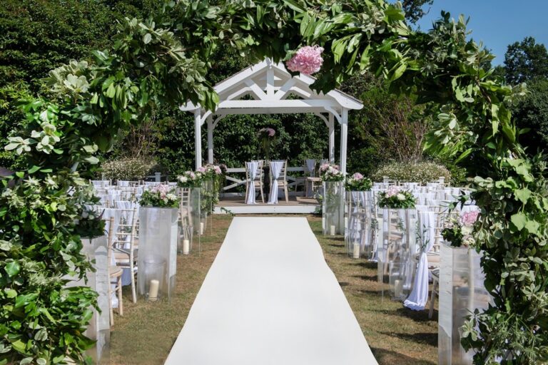 A white aisle to the wedding pavilion among flowers, De Vere Wokefield Estate