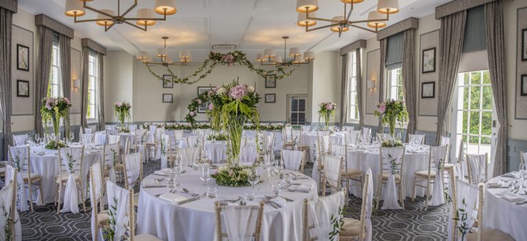 A suite set with round tables and flower centrepieces, De Vere Wokefield Estate