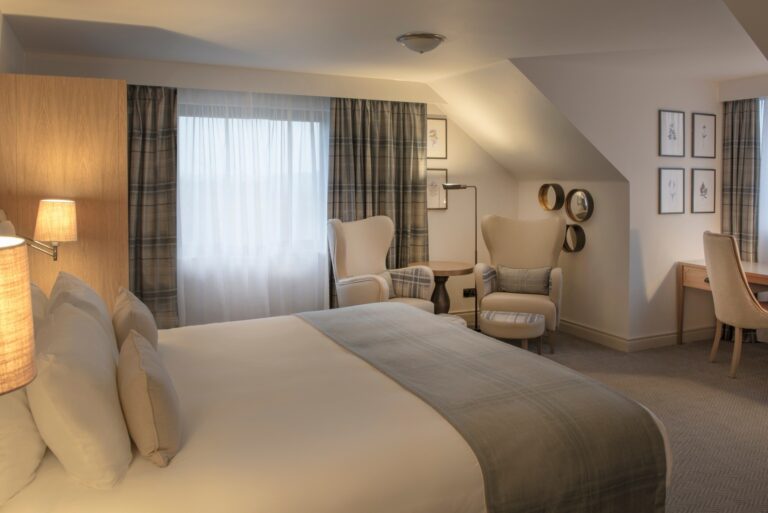 A bedroom with a sitting area, De Vere Wokefield Estate