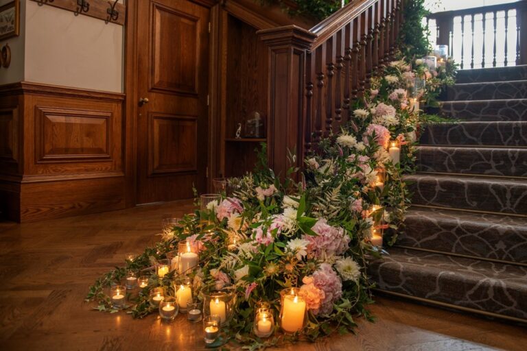 Candles and flowers on the mansion staircase, De Vere Wokefield Estate