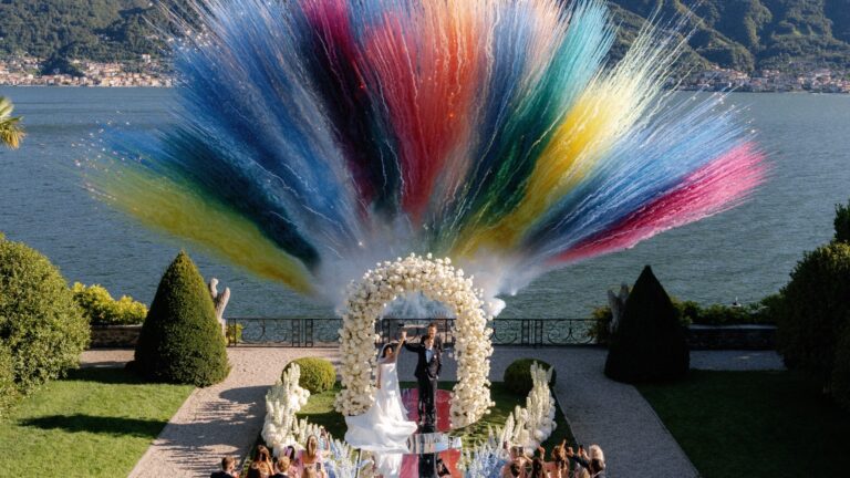The ceremony at Villa Balbiano seen from above, with a coloured installation behind the arch, Lake Como, Denee Motion