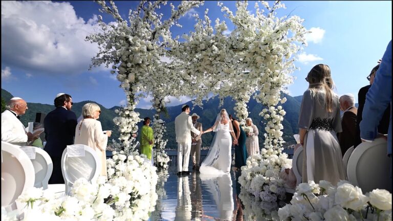 G and S under a white flower chuppah by the lake at Villa Balbiano, Lake Como (still from their film), Denee Motion