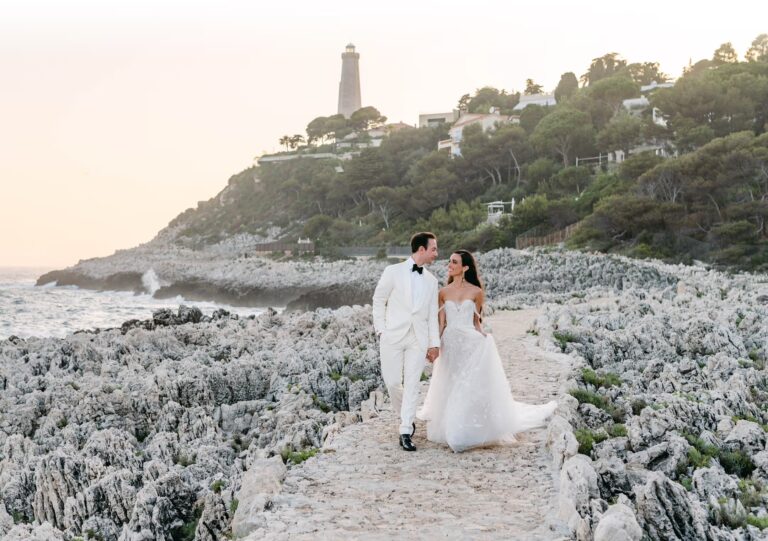 A couple walk the coastal path below the Cap Ferrat lighthouse, Denee Motion