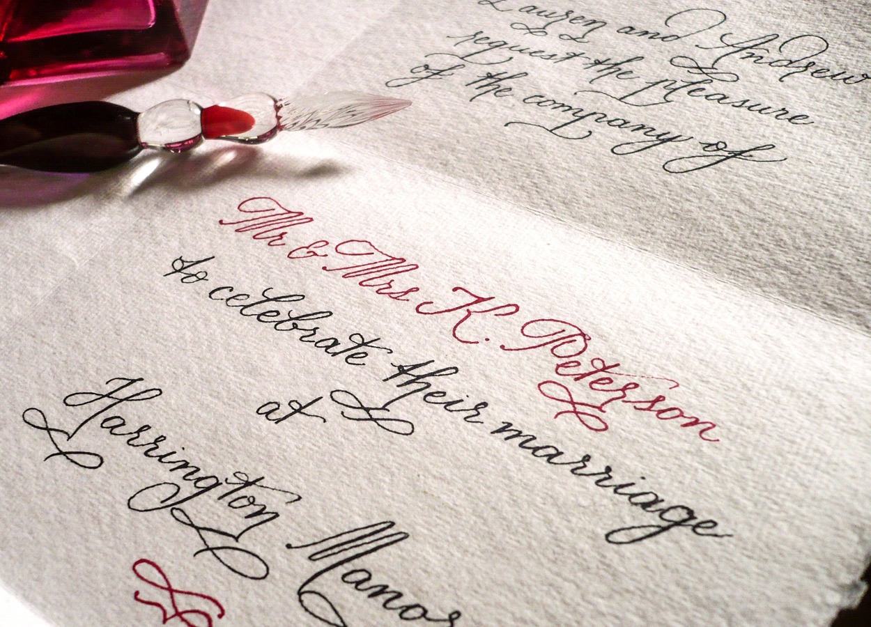 Wedding invitation written by hand in black and red ink on deckle edged paper, Denise Hagon Calligrapher