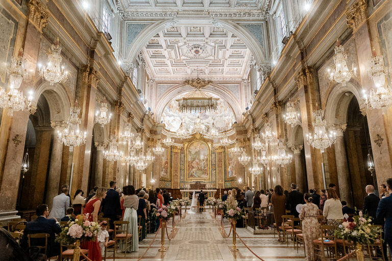 A wedding ceremony in the Basilica dei Santi Giovanni e Paolo, Rome, under its rows of crystal chandeliers, Denise More