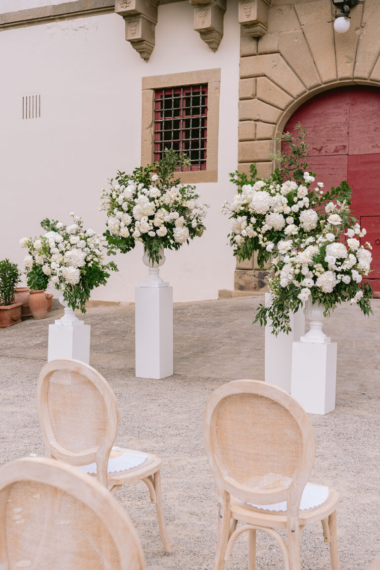 Ceremony set-up with white flower columns before the villa at Tenuta di Artimino, Tuscany, Denise More