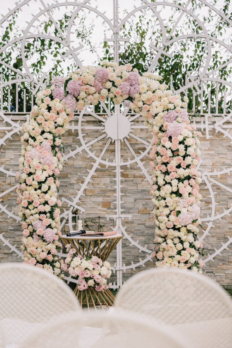 A rose arch against white ironwork for a ceremony on the Amalfi Coast, Denise More