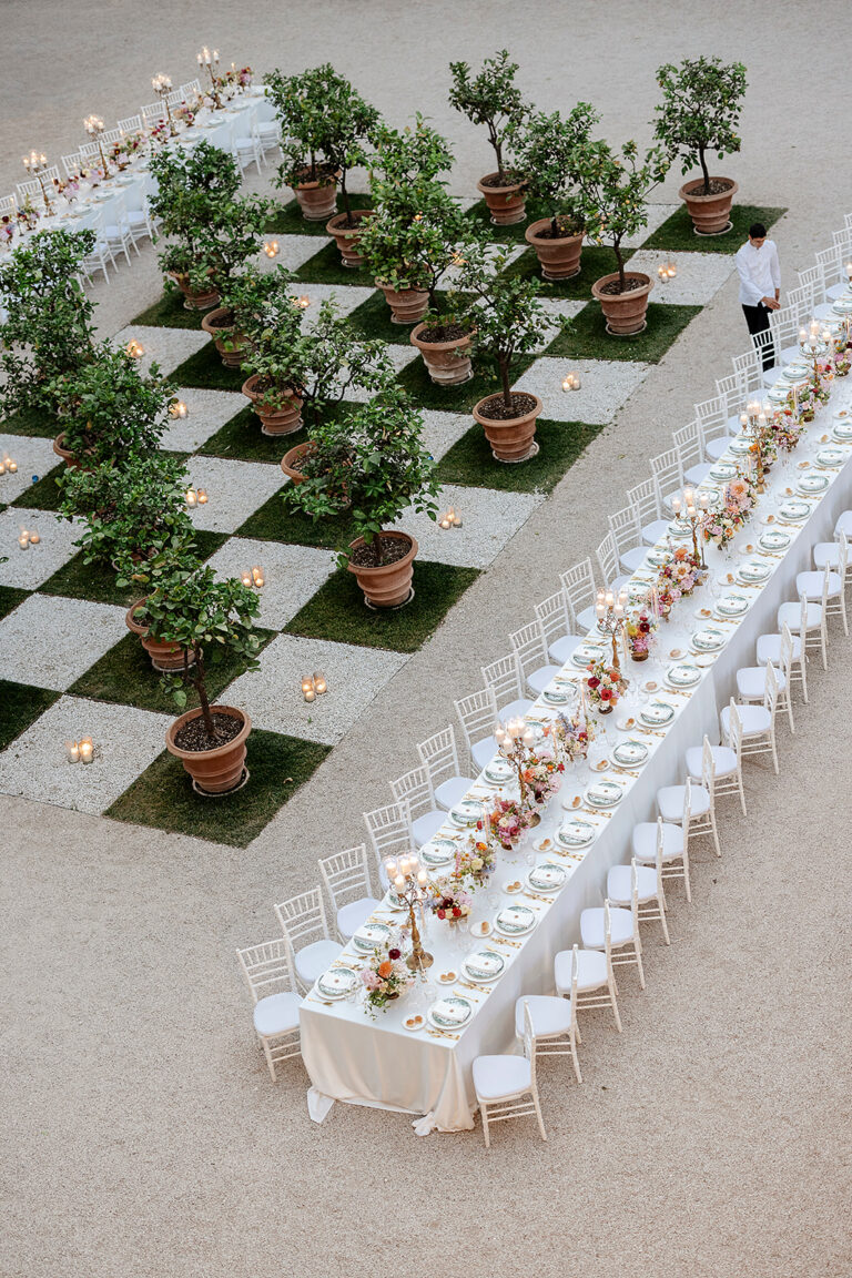 Overhead view of the long dinner table running between the lemon trees at Villa Aurelia, Denise More