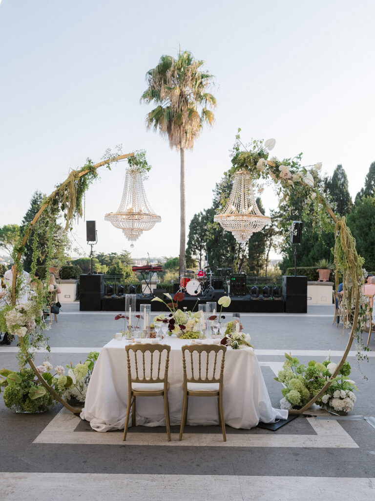 Crystal chandeliers hung from greenery arches over the top table on the terrace at Villa Miani, Rome, Denise More