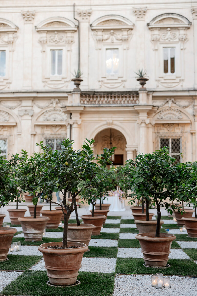 Dinner set among potted lemon trees on a chequered lawn before the facade of Villa Aurelia, Rome, Denise More