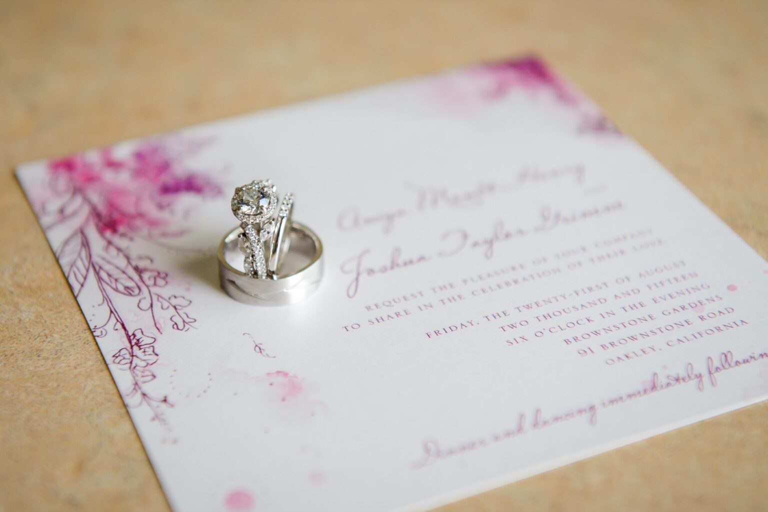An invitation card with the wedding rings resting on it, Despina Craig Events