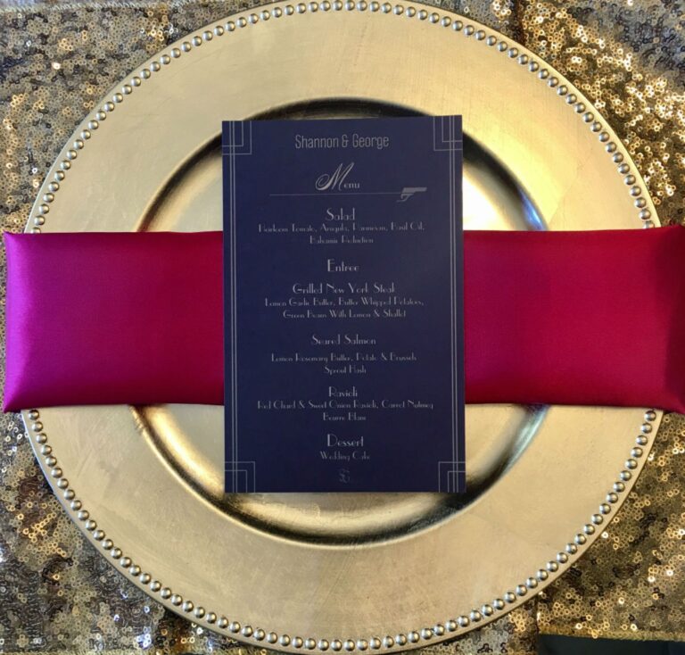 A navy menu card on a fuchsia napkin and gold sequin charger, Despina Craig Events