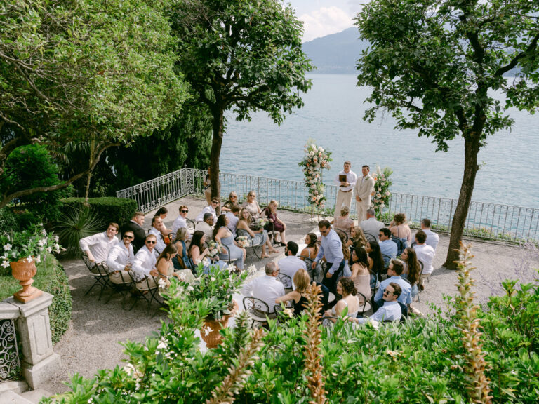 The ceremony from above: guests seated in the garden on the water's edge. Brooke and Austin's wedding at Villa Cipressi, Lake Como, Detito Photography