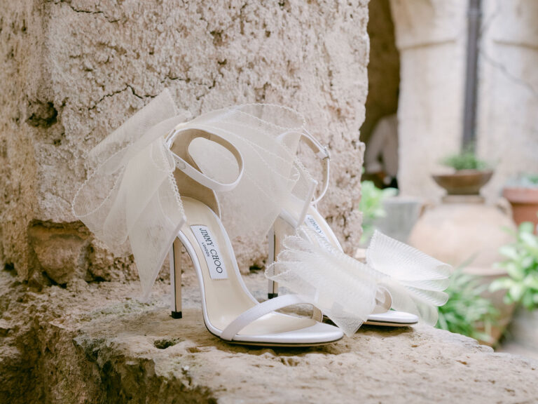 Bridal sandals set on an old stone ledge. Alex and Andrew's wedding at Villa Cimbrone, Ravello, Amalfi Coast, Detito Photography