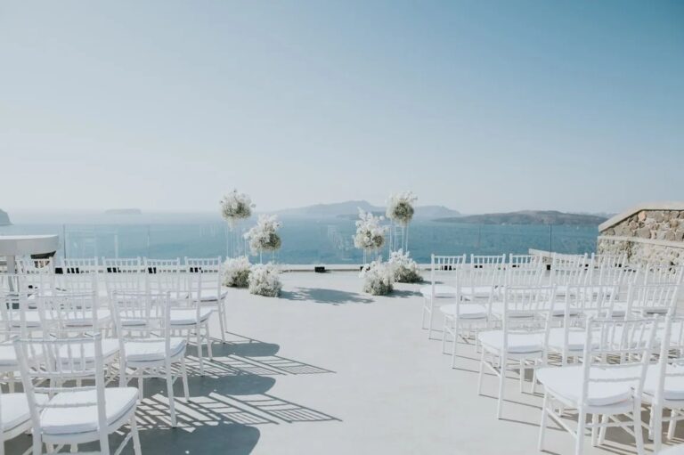 White ceremony chairs facing the caldera at Cavo Ventus, Santorini, Diamond Rock Santorini