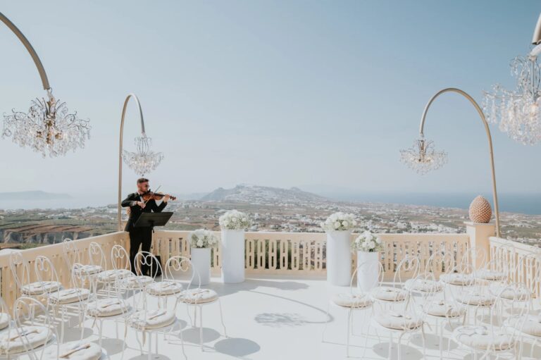 Ceremony chairs and chandeliers on a terrace with a violinist, Santorini, Diamond Rock Santorini