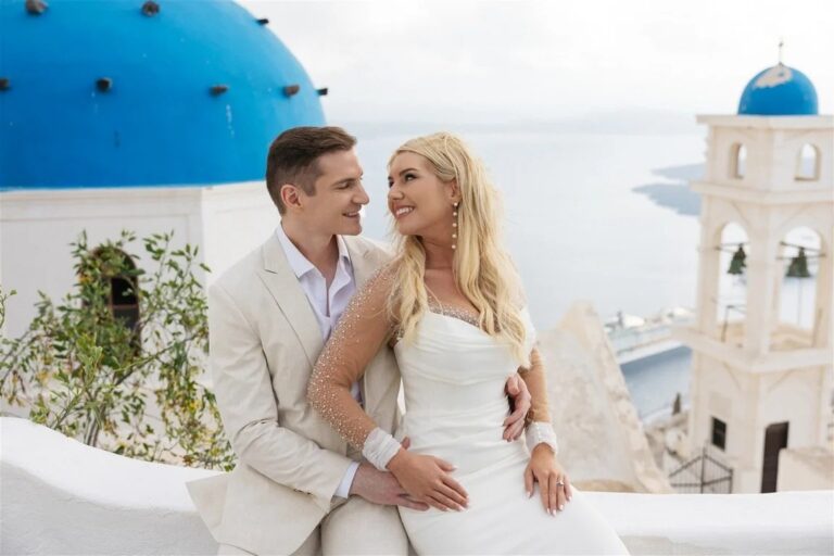 A couple beside a blue-domed church in Santorini, Diamond Rock Santorini