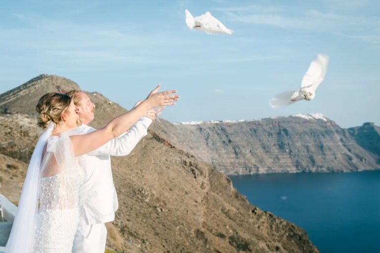 A couple releasing doves on the caldera edge in Santorini, Diamond Rock Santorini