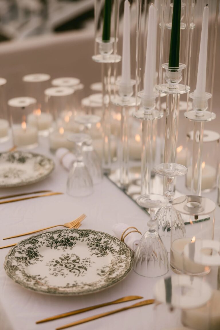 Painted plates and tall candles on a wedding table at Love Cave Venue, Santorini, Diamond Rock Santorini