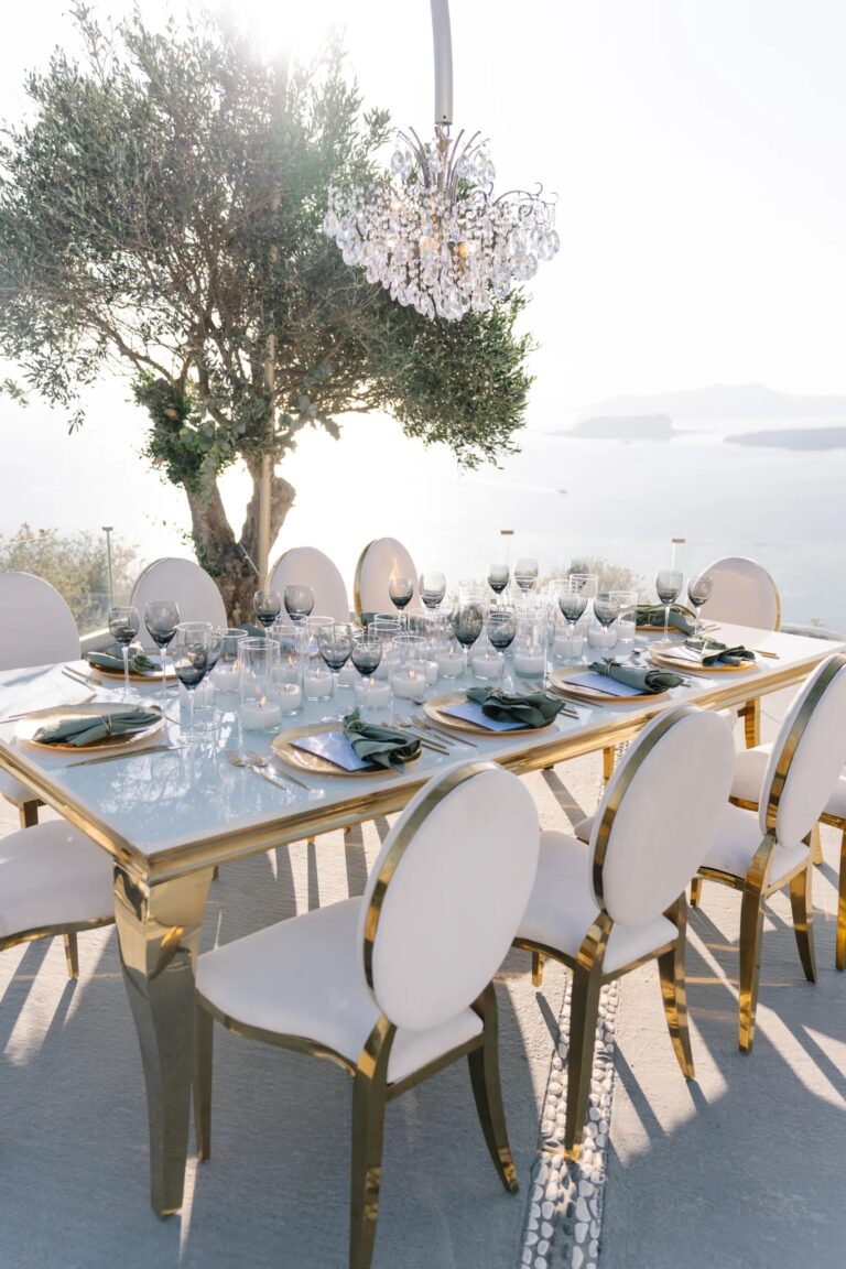 A gold-framed banquet table beneath an olive tree at Thermes, Santorini, Diamond Rock Santorini