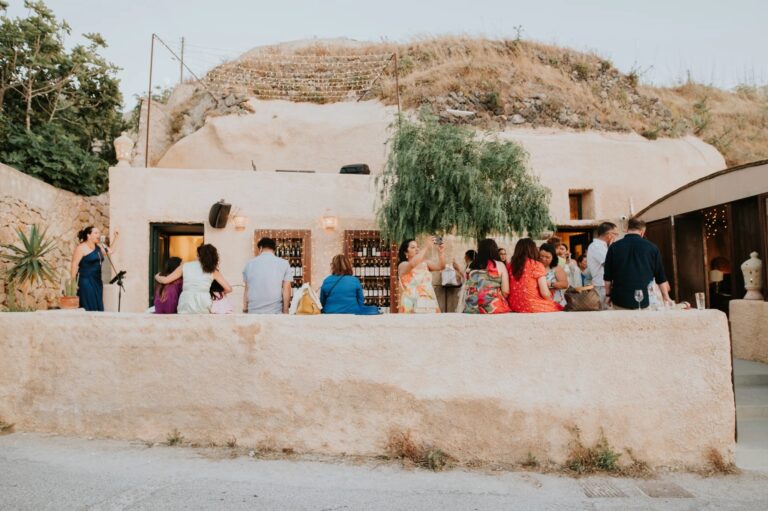 Guests gathering outside a whitewashed cave house in Santorini, Diamond Rock Santorini
