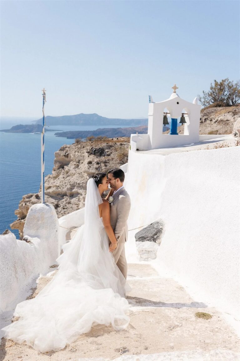 A bride and groom by the whitewashed chapel at Venetsanos Winery, Santorini, Diamond Rock Santorini