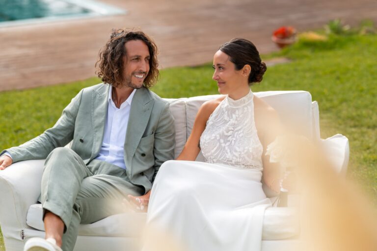 The couple laugh together on a white sofa on the lawn, Casal do Frade, Sesimbra, Dimas Frolov Photography