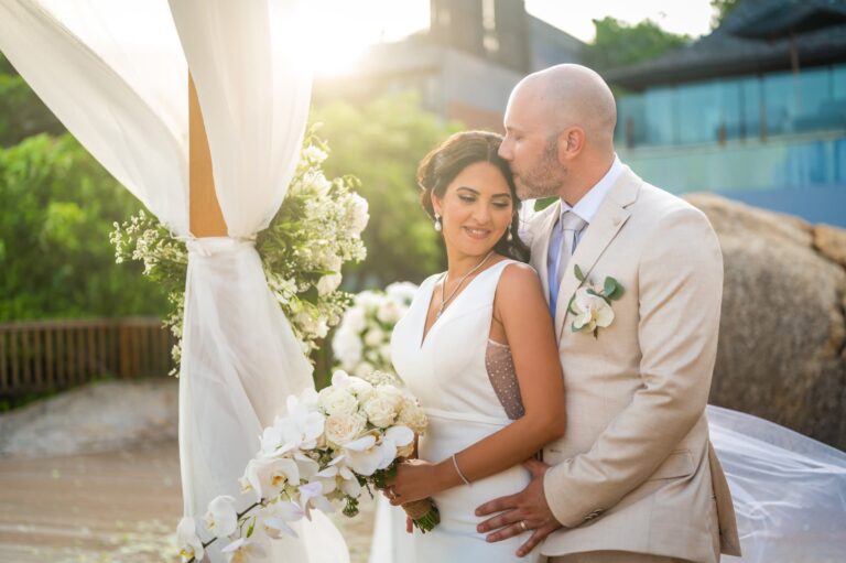 The couple embrace beside the arch in low golden light, Dimas Frolov Photography