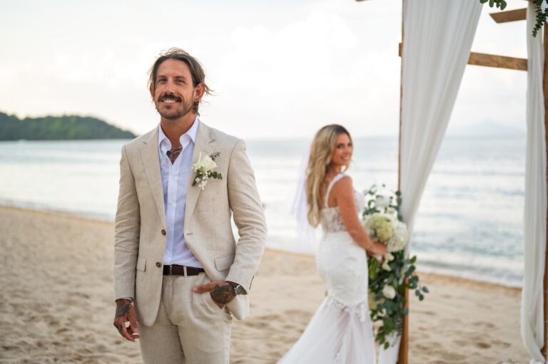The couple on the sand beside the ceremony arch, golden evening light, Dimas Frolov Photography