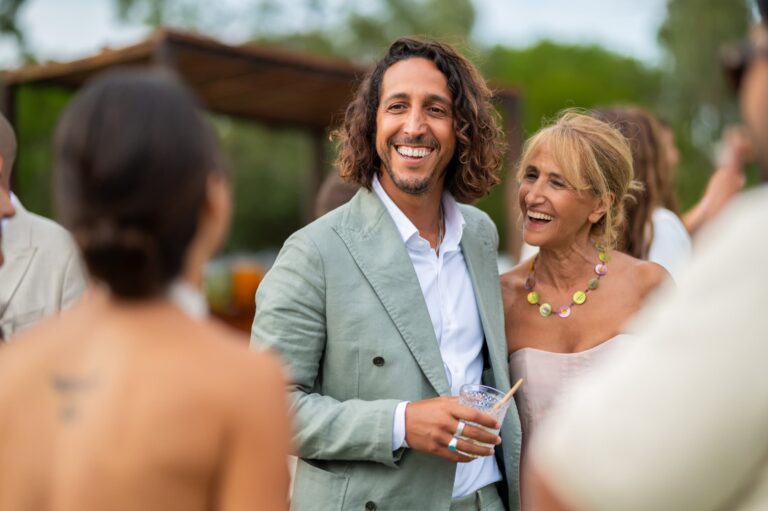 The groom laughing among guests after the ceremony, Casal do Frade, Sesimbra, Dimas Frolov Photography