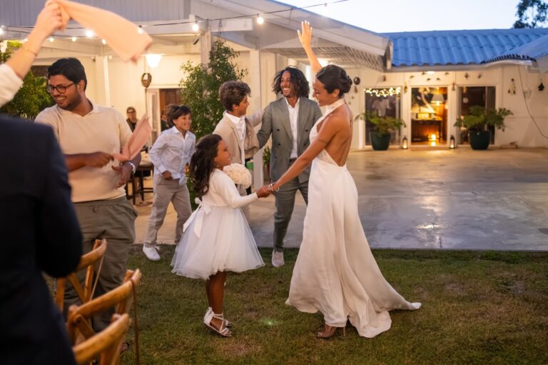 The bride dances with a young guest under festoon lights, Casal do Frade, Sesimbra, Dimas Frolov Photography