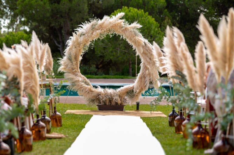 A circular pampas arch at the end of the aisle, beside the pool at Casal do Frade, Sesimbra, Dimas Frolov Photography