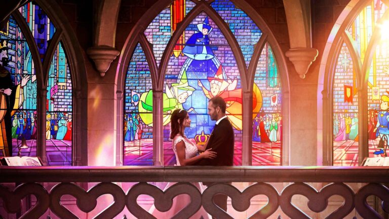 A couple in the stained glass gallery of Sleeping Beauty Castle, Disneyland Paris