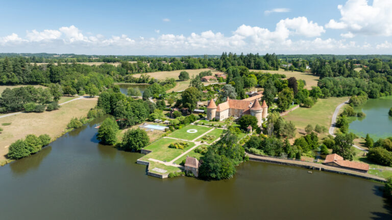 The château and its gardens beside the lake from above, Domaine des Etangs, Auberge Collection
