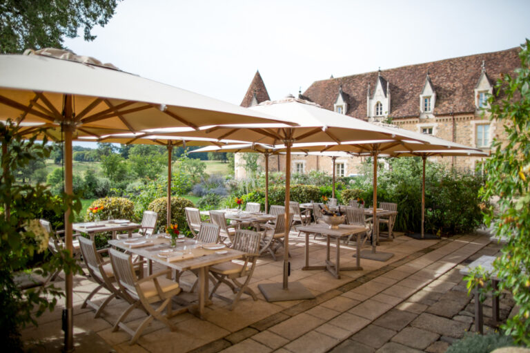 The Dyades terrace under parasols, Domaine des Etangs, Auberge Collection