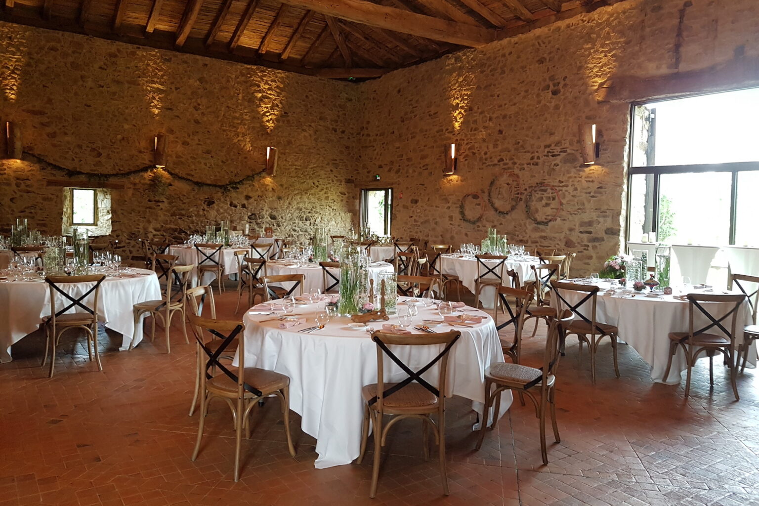 Octave, the stone barn, set for a wedding dinner