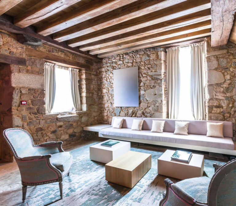 A suite sitting area with stone walls, Domaine des Etangs, Auberge Collection